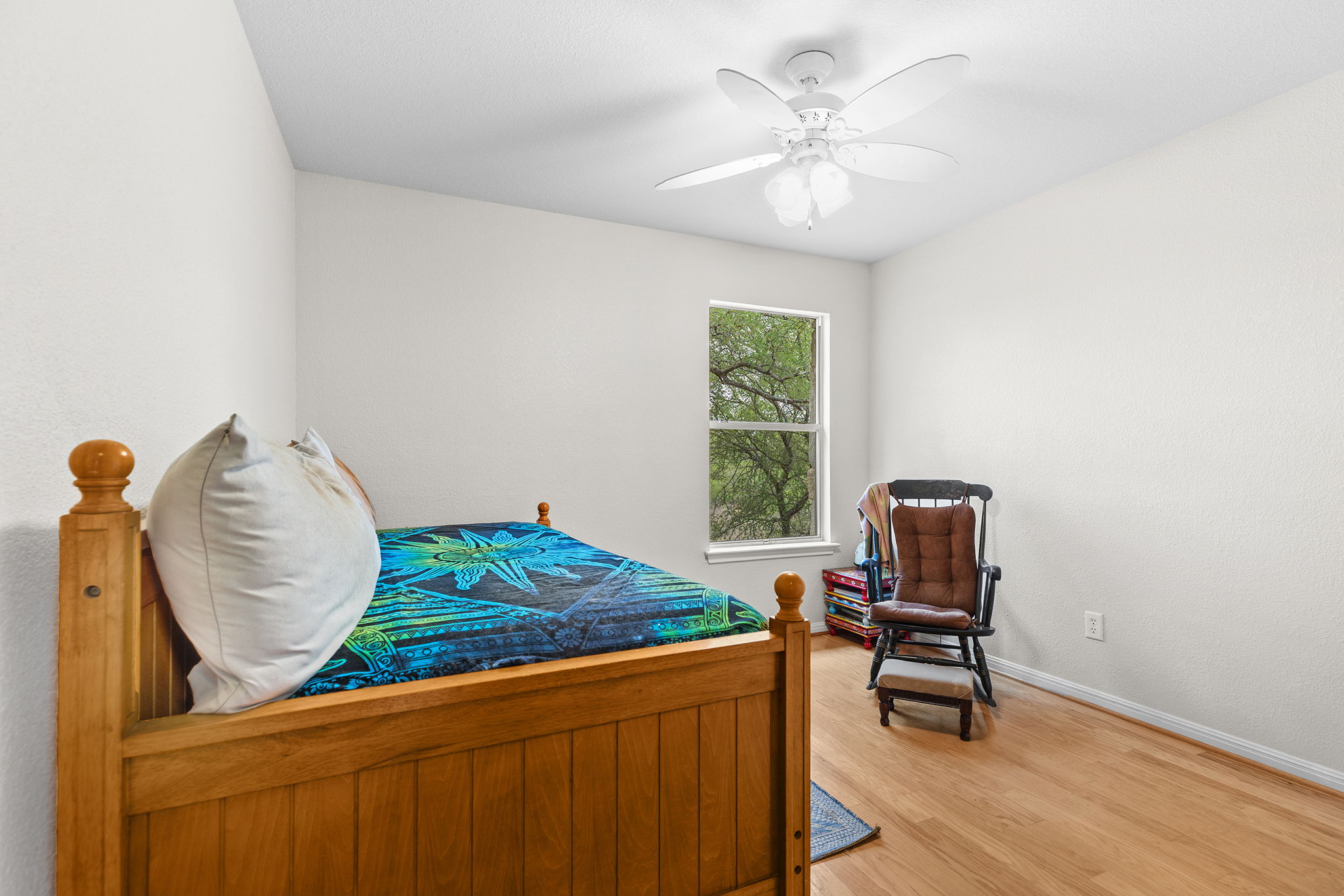 202 The Oaks Boulevard Elgin, TX 78621 - Photo 26 of 40 Bedroom featuring wood finished floors and a ceiling fan
