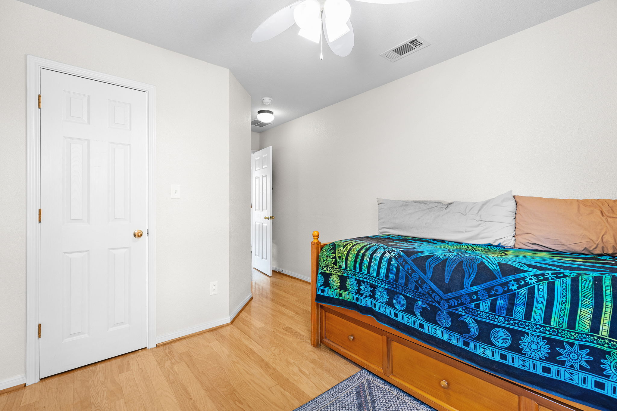 202 The Oaks Boulevard Elgin, TX 78621 - Photo 27 of 40 Bedroom with light wood-style floors and ceiling fan