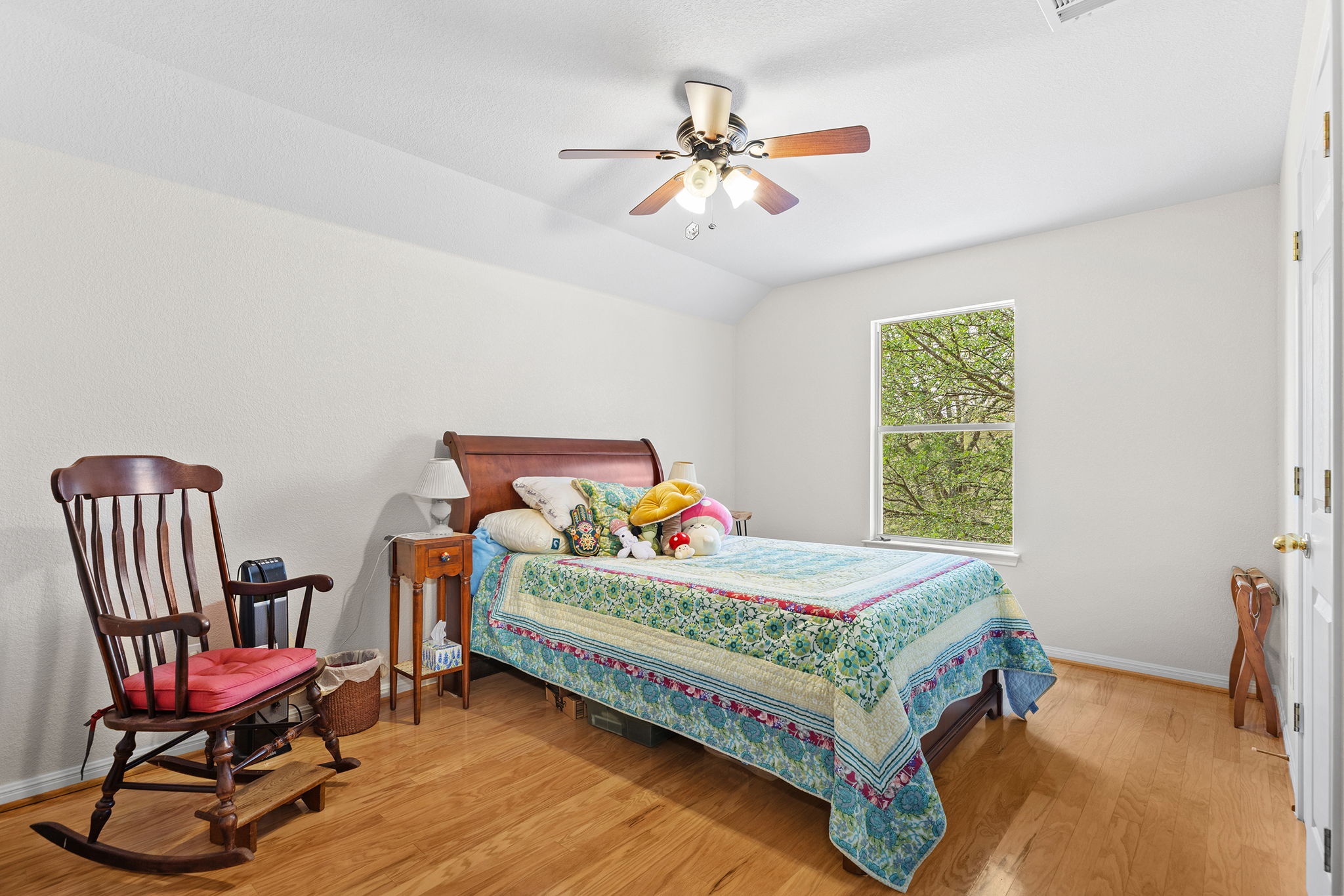 202 The Oaks Boulevard Elgin, TX 78621 - Photo 29 of 40 Bedroom with light wood finished floors, ceiling fan, and vaulted ceiling