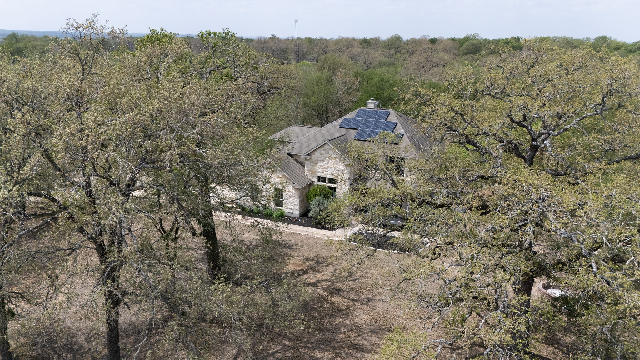 202 The Oaks Boulevard Elgin, TX 78621 - Photo 36 of 40 Aerial view of property and surrounding area featuring a forest