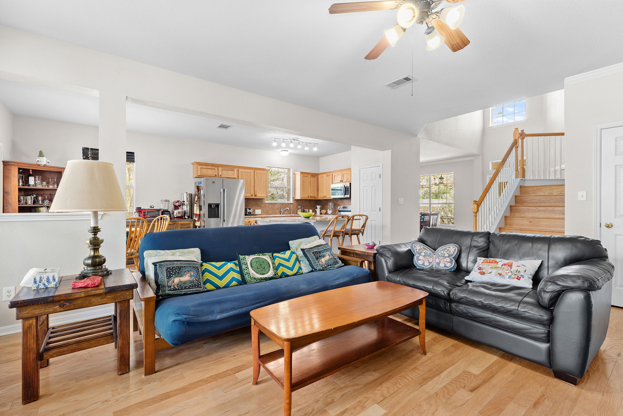 202 The Oaks Boulevard Elgin, TX 78621 - Photo 4 of 40 Living room with a ceiling fan, light wood-style flooring, and healthy amount of natural light