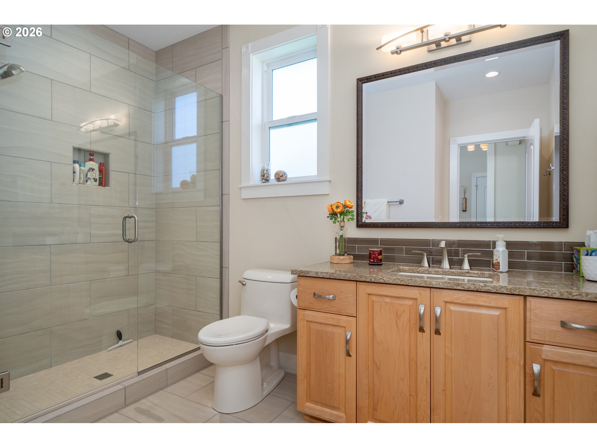 175 Southwest 59th Street South Beach, OR 97366 - Photo 16 of 48 a bathroom with a granite countertop sink a toilet a mirror and shower