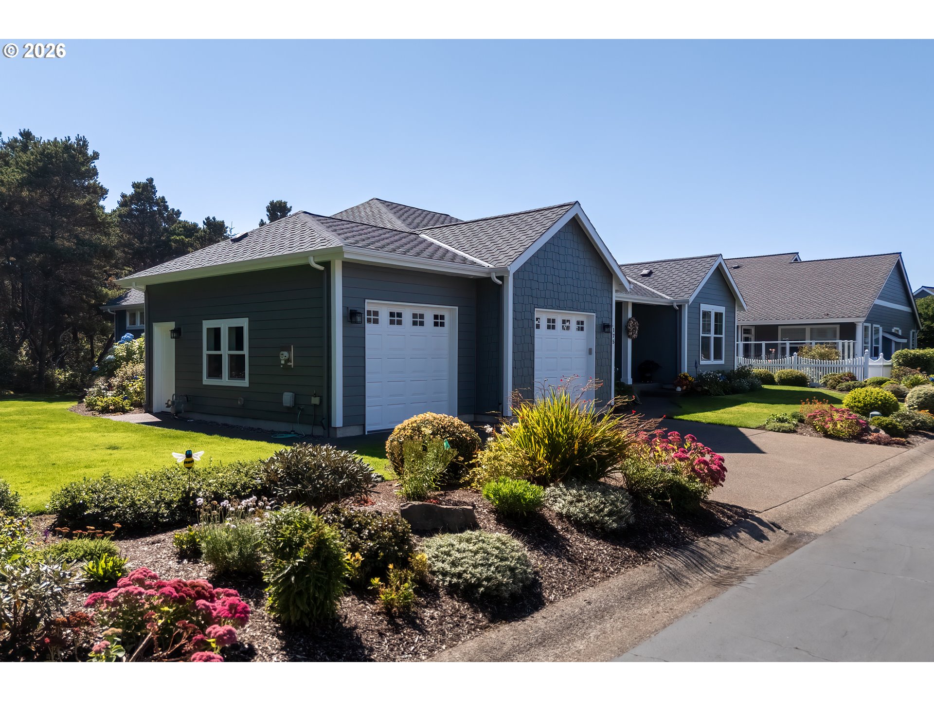 175 Southwest 59th Street South Beach, OR 97366 - Photo 8 of 48 a view of a house with a garden and pathway