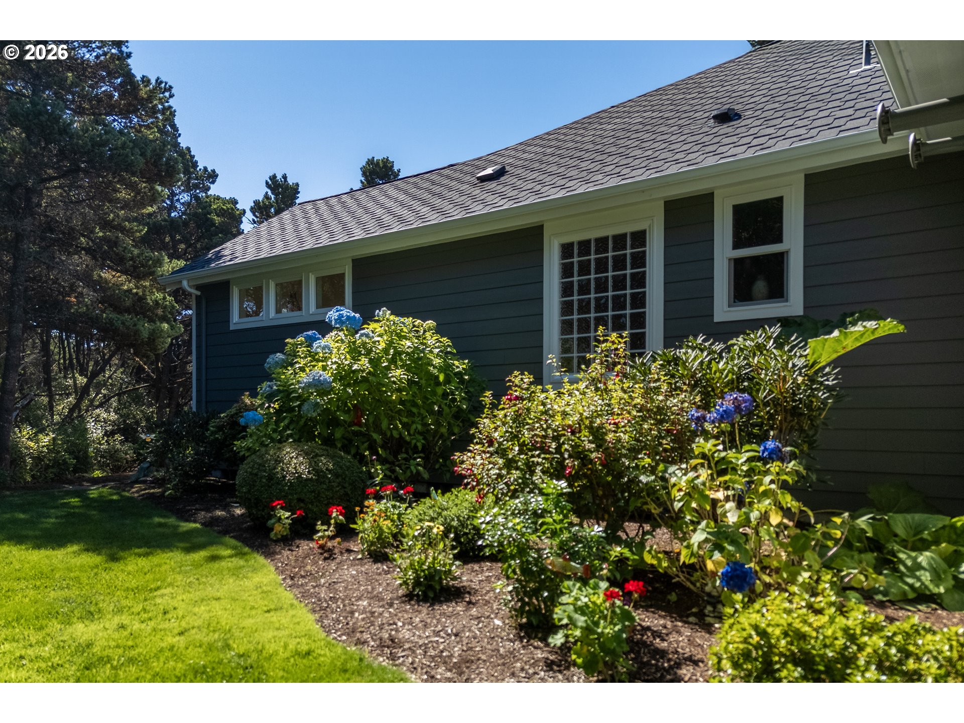 175 Southwest 59th Street South Beach, OR 97366 - Photo 9 of 48 a front view of a house with a yard