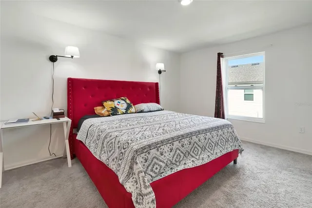 a bedroom with a bed and window