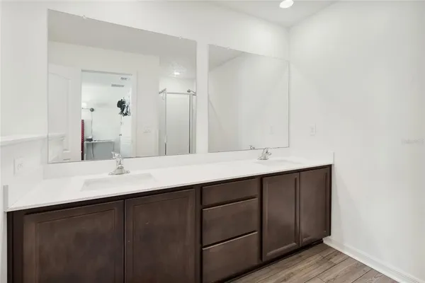 a bathroom with a double vanity sink and mirror