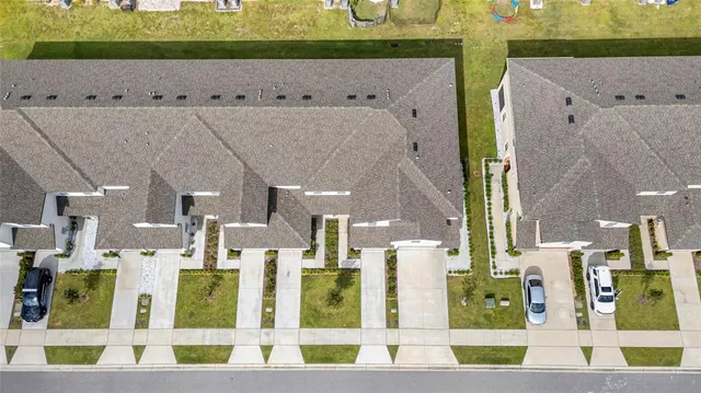 a view of an house with backyard and tree