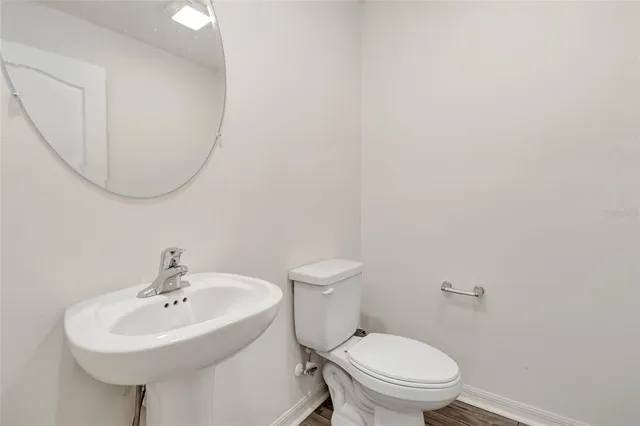 a white toilet sitting next to a white sink