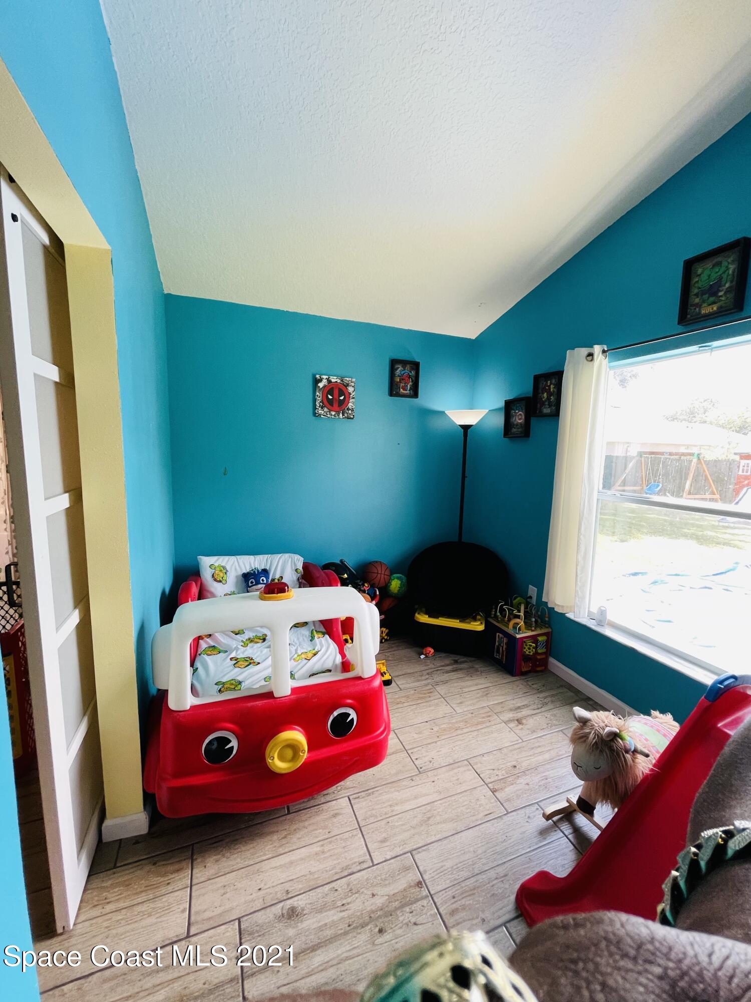2374 Angel Road Palm Bay, FL 32909 - Photo 11 of 19 a bedroom with a bed and a window
