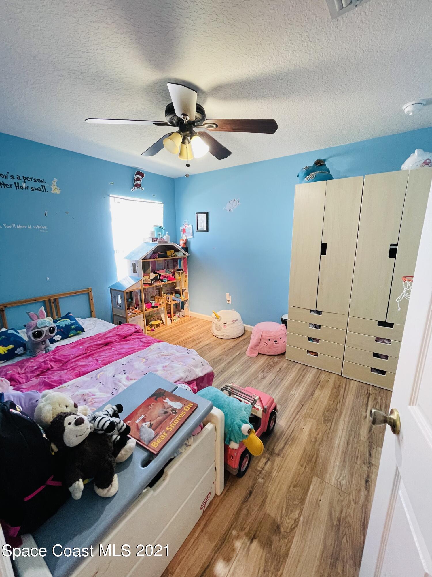2374 Angel Road Palm Bay, FL 32909 - Photo 13 of 19 a view of a room with furniture and wooden floor