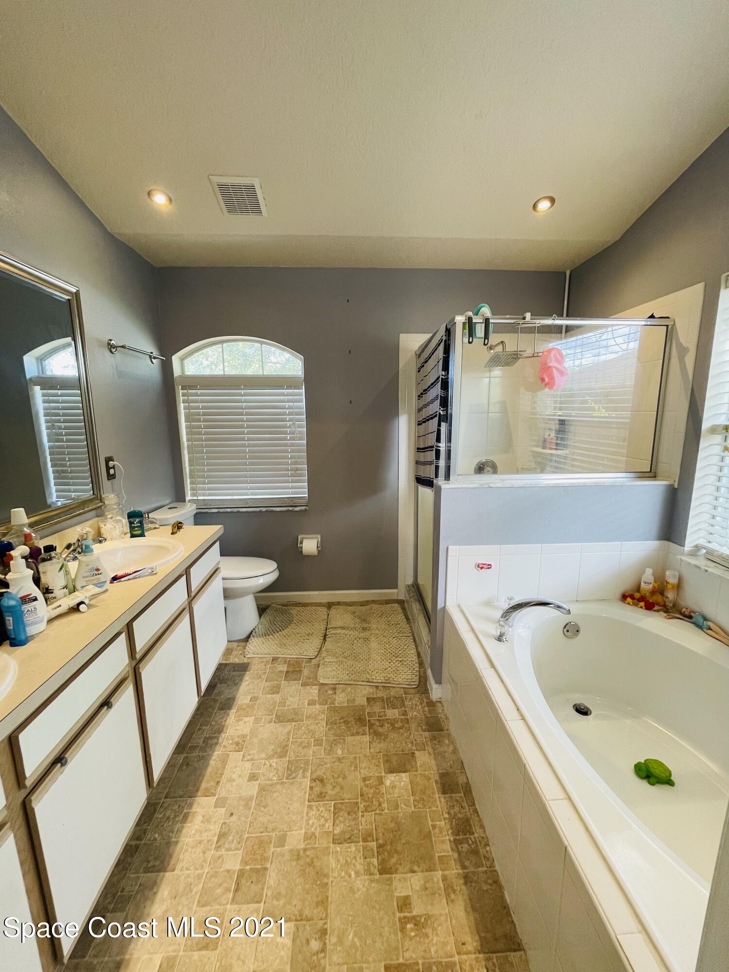 2374 Angel Road Palm Bay, FL 32909 - Photo 16 of 19 a view of walk in closet with clothes and shoes