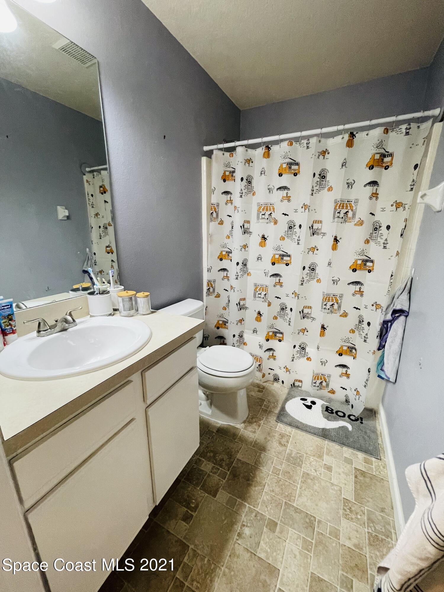 2374 Angel Road Palm Bay, FL 32909 - Photo 17 of 19 a bathroom with a tub sink and mirror