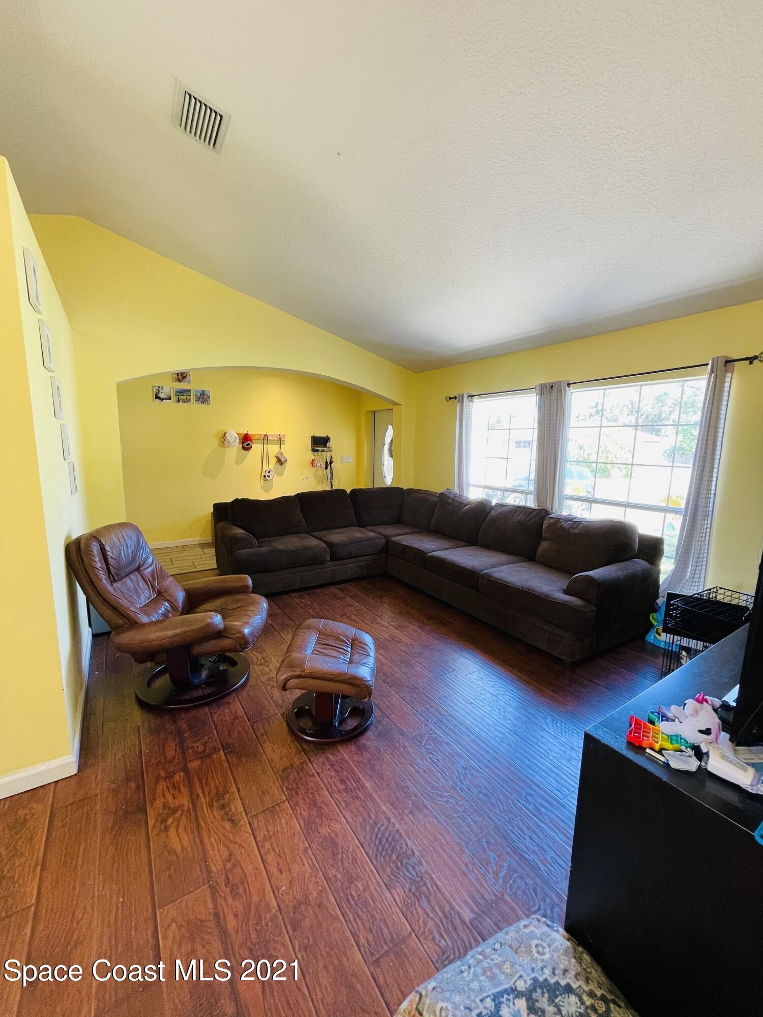 2374 Angel Road Palm Bay, FL 32909 - Photo 3 of 19 a living room with furniture and a lamp