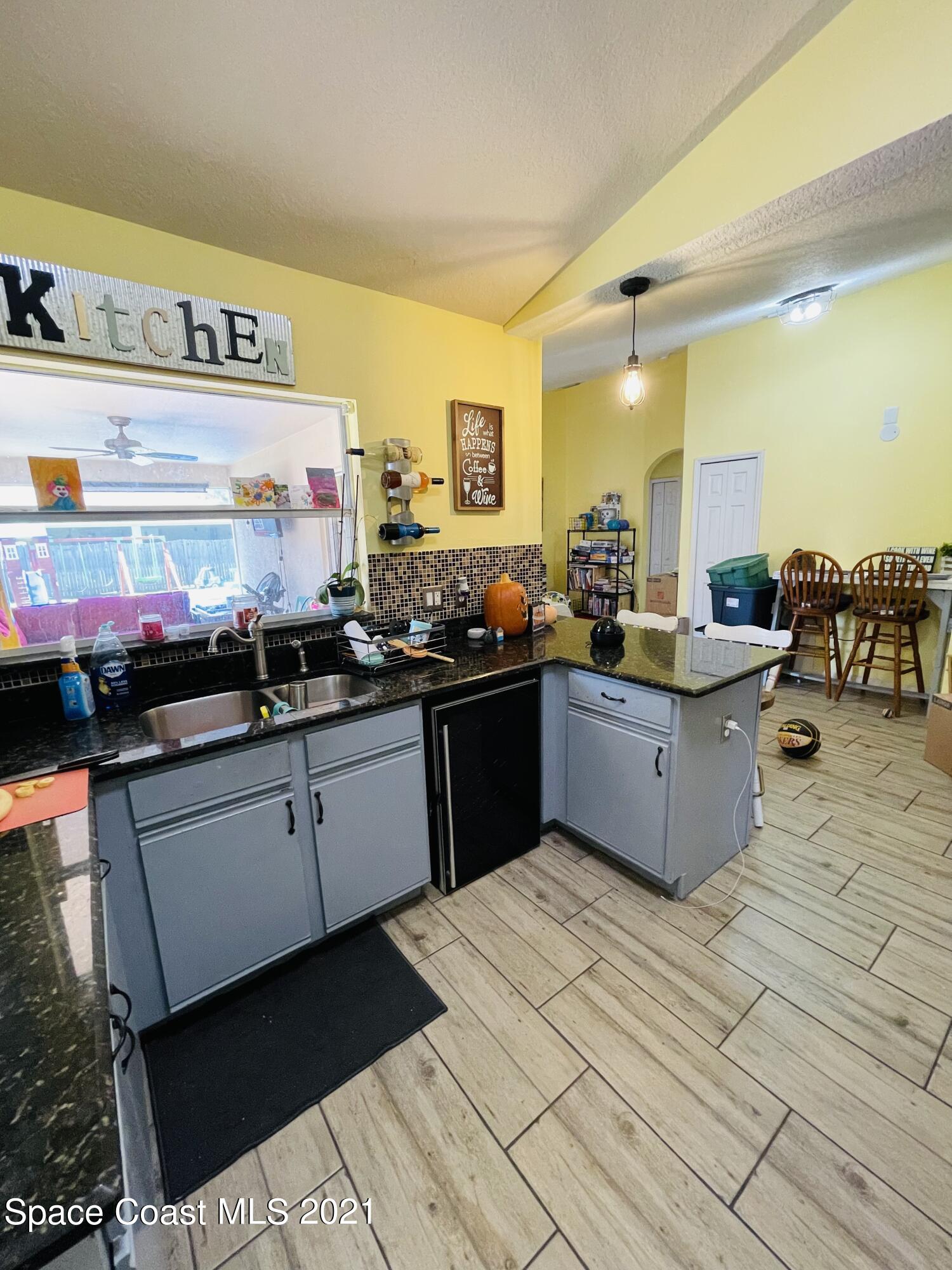 2374 Angel Road Palm Bay, FL 32909 - Photo 6 of 19 a kitchen with stainless steel appliances kitchen island granite countertop a sink and cabinets