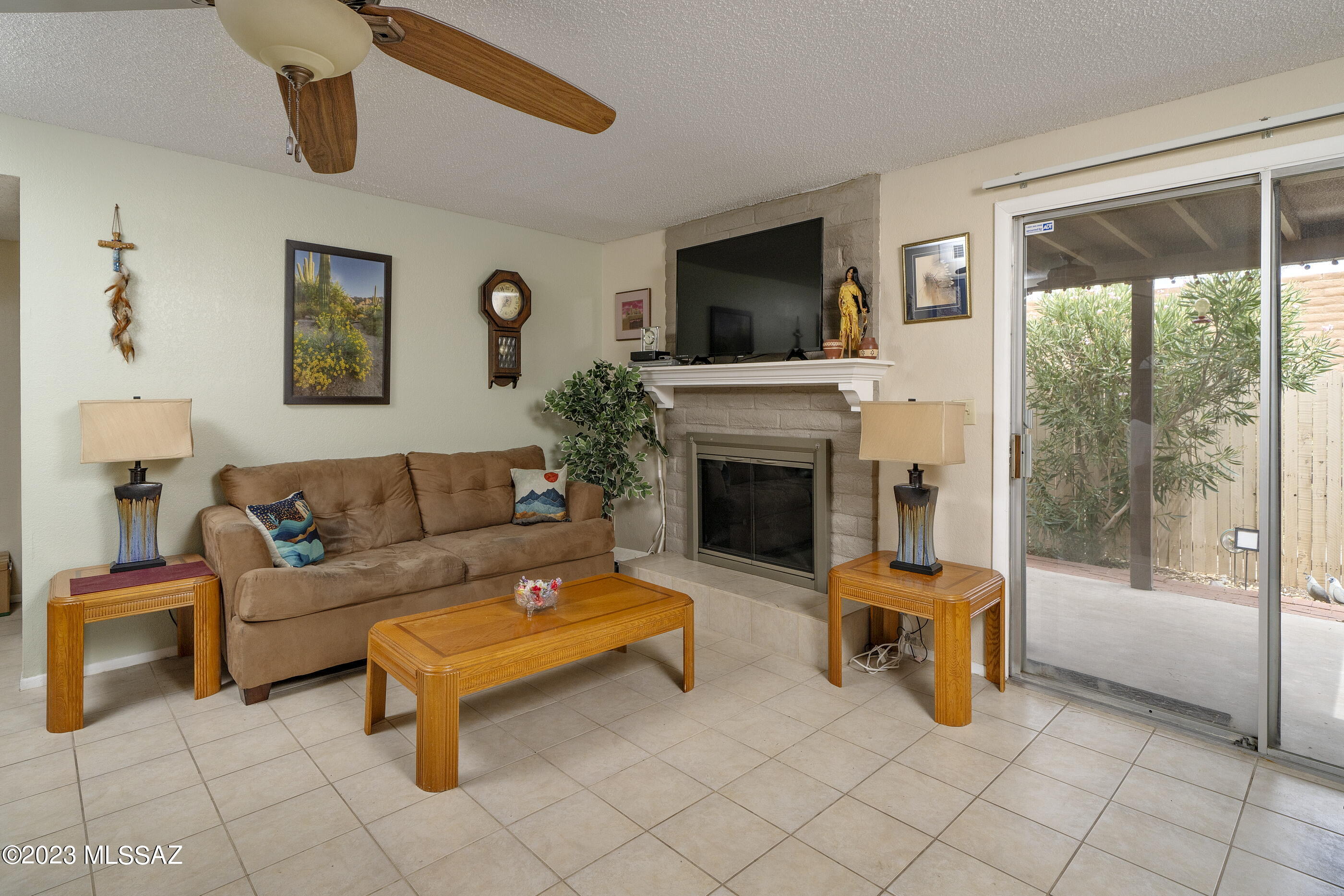 670 South Pantano Road, Unit E Tucson, AZ 85710 - Photo 8 of 17 a living room with furniture a flat screen tv and a fireplace