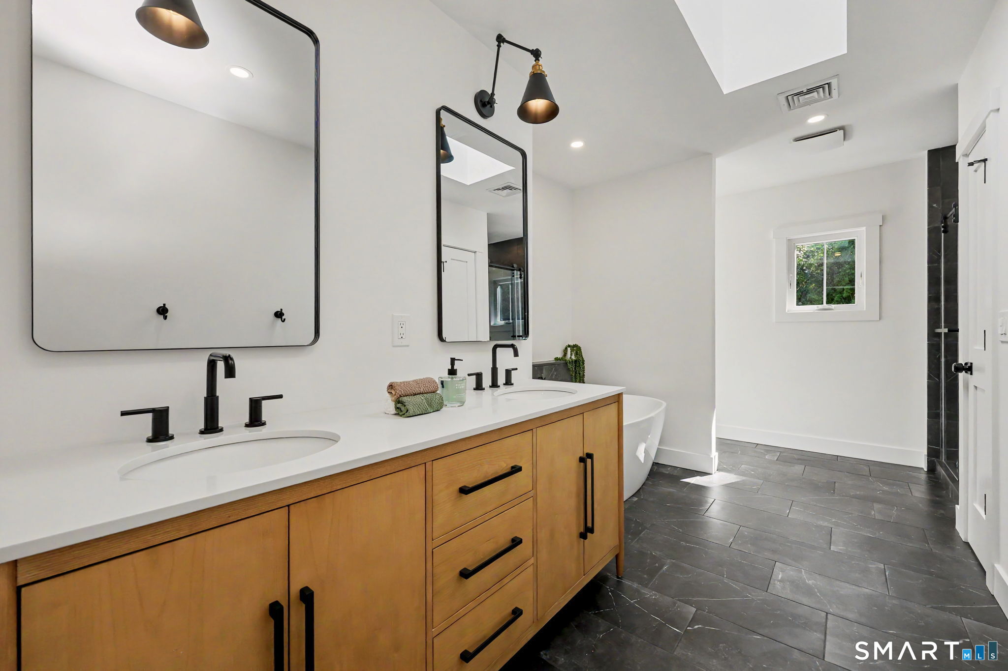 91 Lockwood Road Fairfield, CT 06825 - Photo 26 of 38 a bathroom with a double vanity sink and a mirror