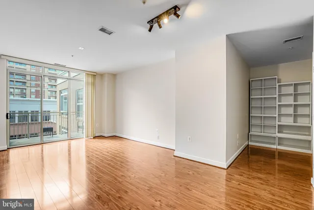 a view of an empty room with wooden floor
