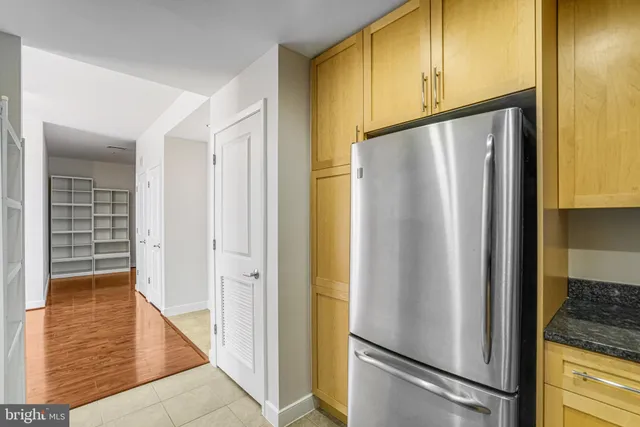 a kitchen with stainless steel appliances granite countertop a stove a sink and dishwasher with white cabinets