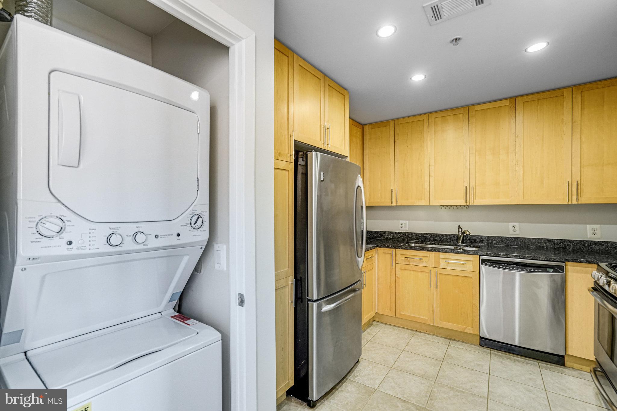 820 North Pollard Street, Unit 915 Arlington, VA 22203 - Photo 16 of 30 a kitchen with a refrigerator sink and cabinets