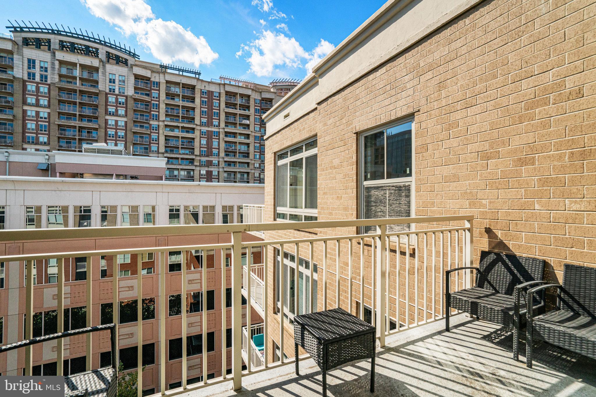 820 North Pollard Street, Unit 915 Arlington, VA 22203 - Photo 24 of 30 a view of a balcony with wooden chairs