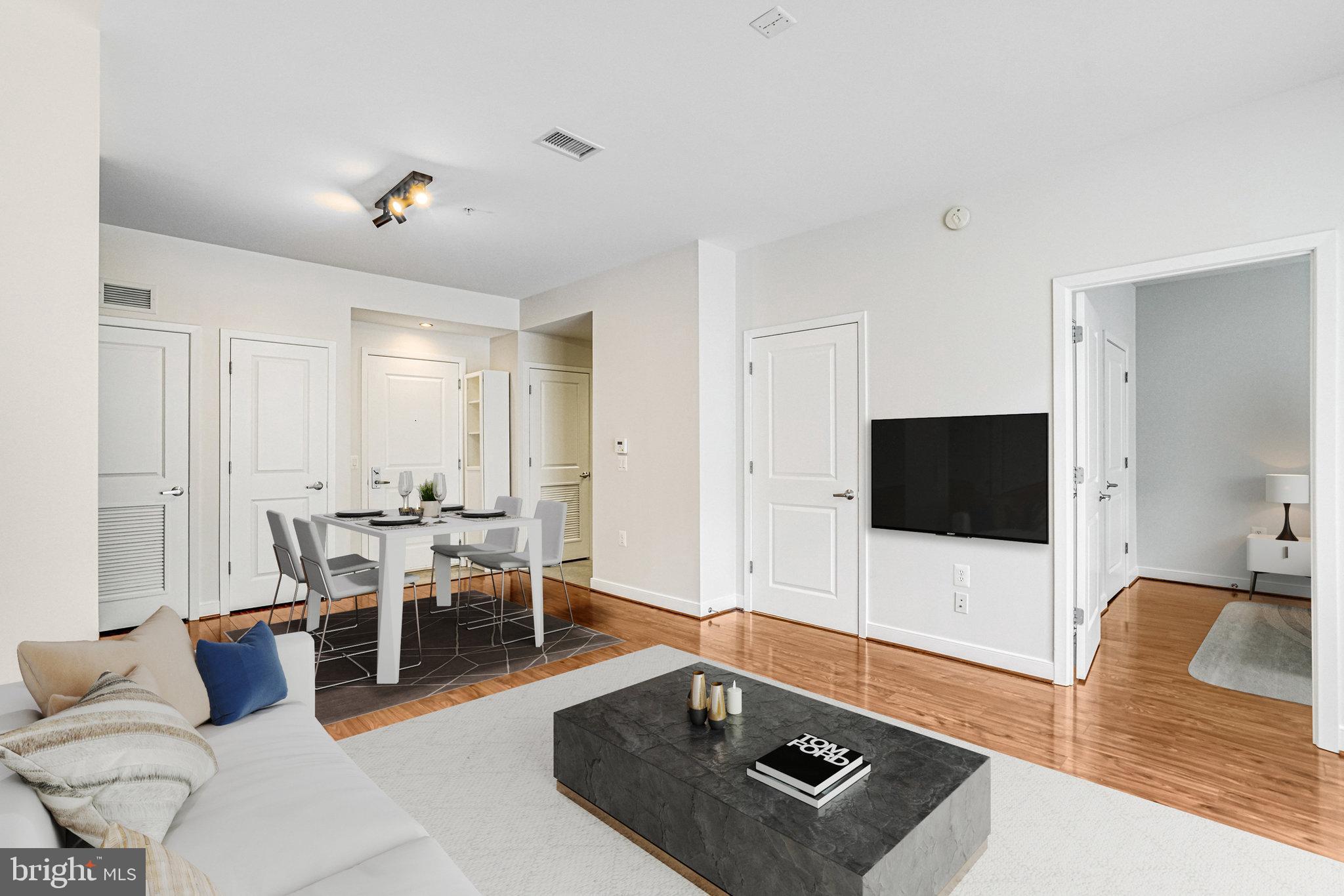 820 North Pollard Street, Unit 915 Arlington, VA 22203 - Photo 3 of 30 a living room with furniture and a flat screen tv