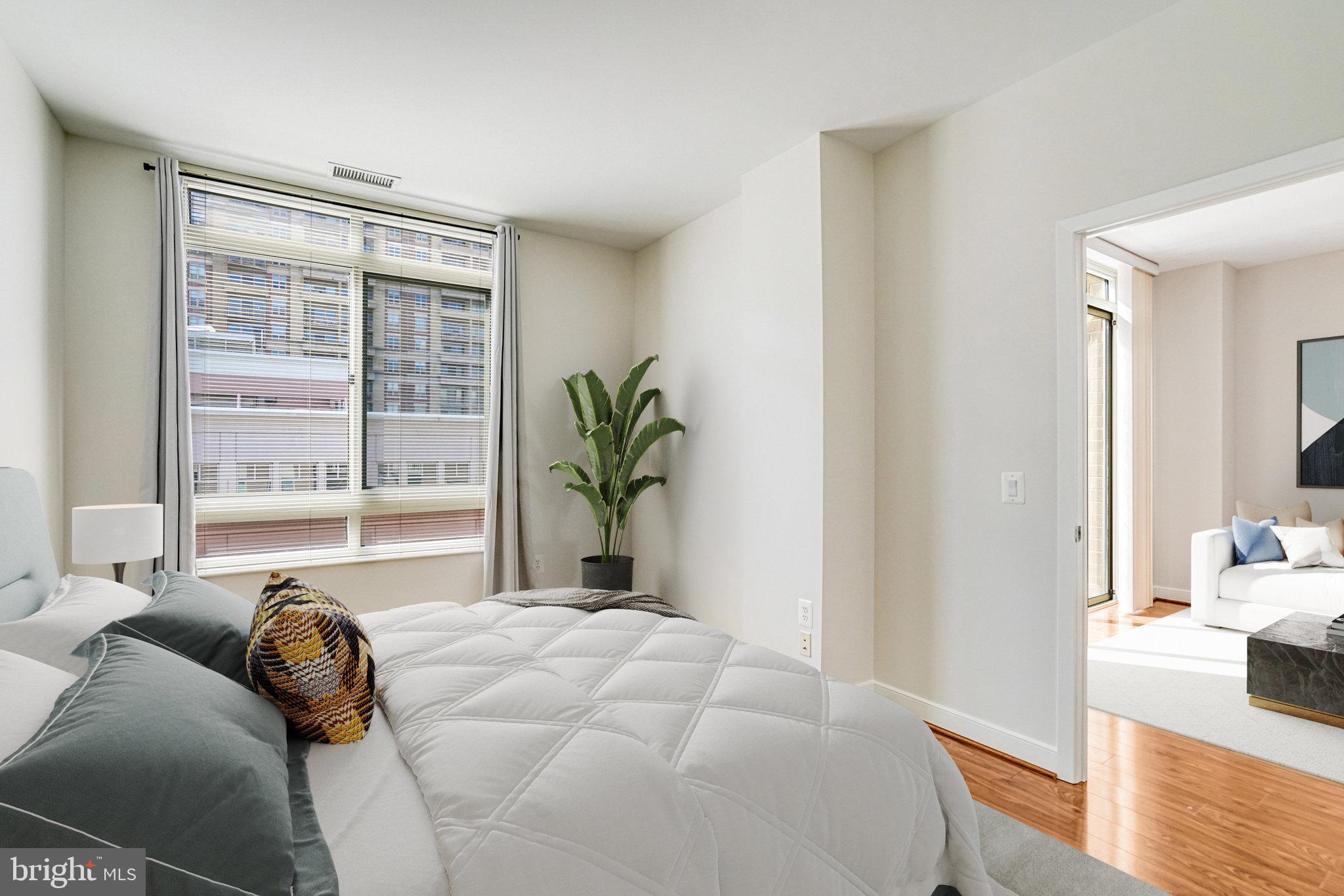 820 North Pollard Street, Unit 915 Arlington, VA 22203 - Photo 5 of 30 a bedroom with a bed and a large window