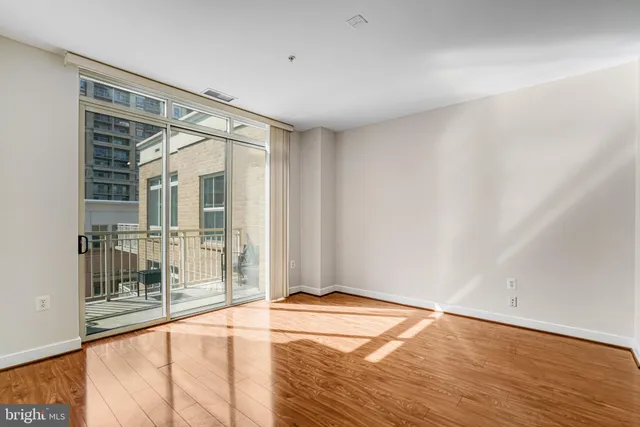 a view of a room with wooden floor and a balcony