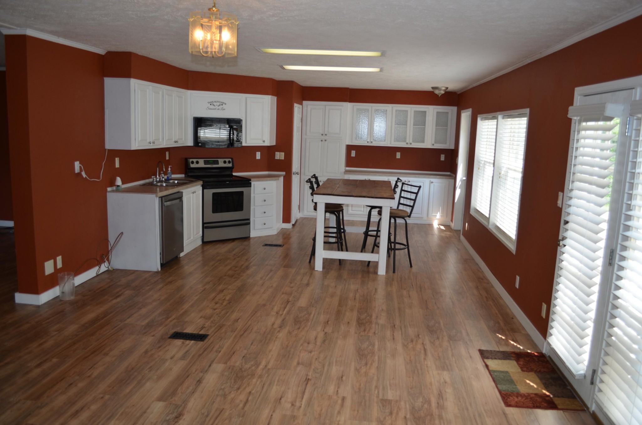 393 Busted Rock Road Old Fort, TN 37362 - Photo 6 of 43 a kitchen with stainless steel appliances a stove a sink dishwasher a microwave oven and a dining table with wooden floor