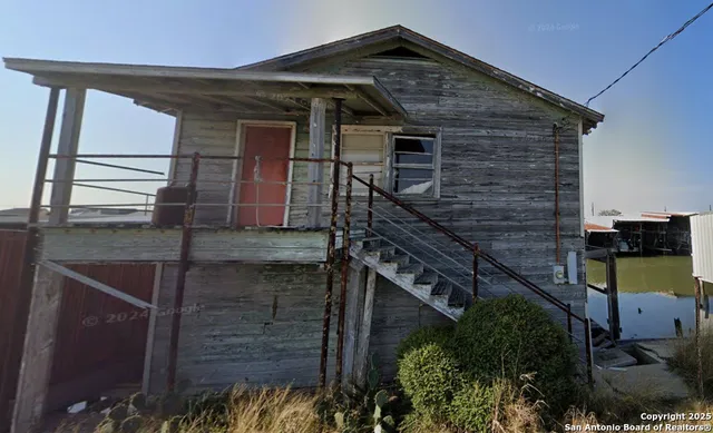 a front view of a house with parking area