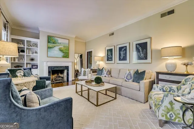 a living room with furniture and a fireplace