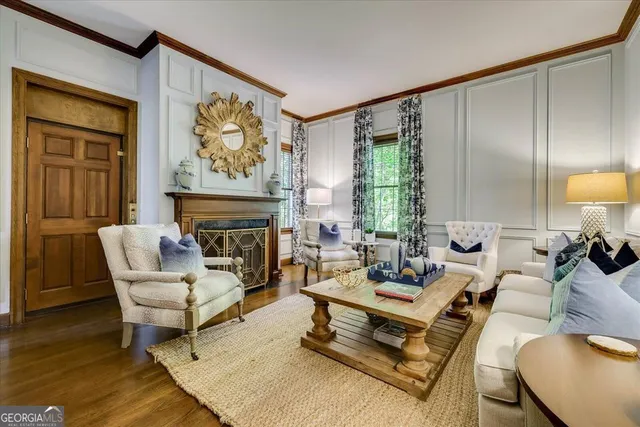 a kitchen with stainless steel appliances a sink a stove top oven a kitchen island with furniture and wooden floor