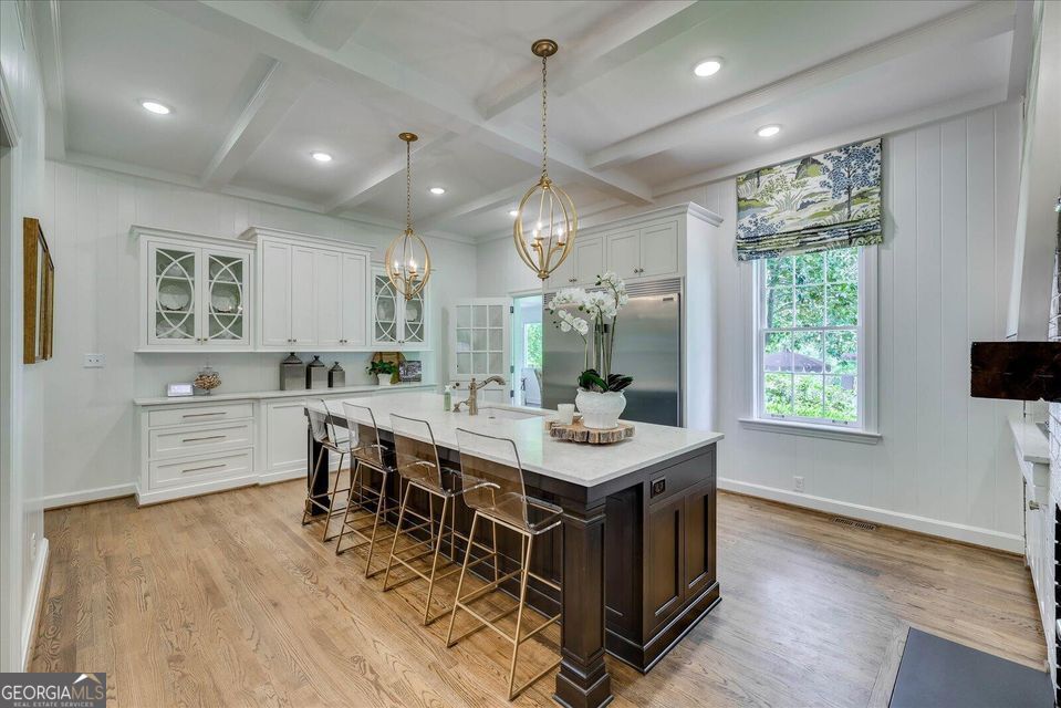 5 Prather Woods Lane Augusta, GA 30909 - Photo 18 of 73 a kitchen with stainless steel appliances a sink a stove top oven a kitchen island with furniture and wooden floor