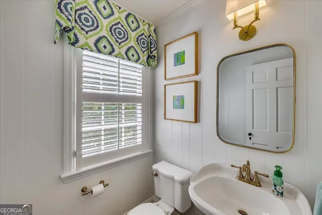 a spacious bedroom with a bed and wooden floor