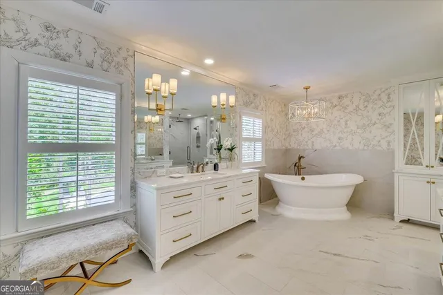 a bedroom with a bed a flat screen tv and a window