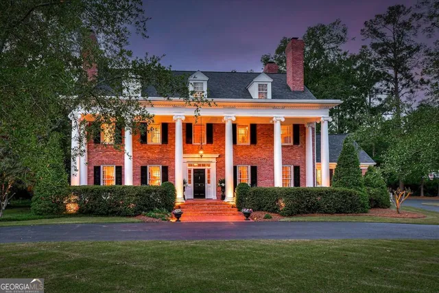 a view of a hallway with wooden floor and a living room