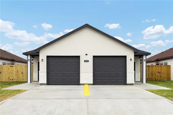 a front view of a house with garage