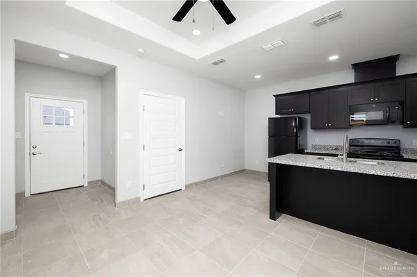a view of kitchen with stainless steel appliances refrigerator stove and microwave