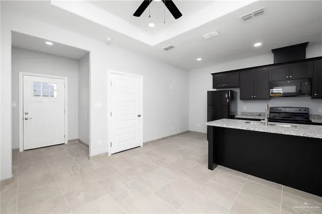 a view of kitchen with stainless steel appliances refrigerator stove and microwave