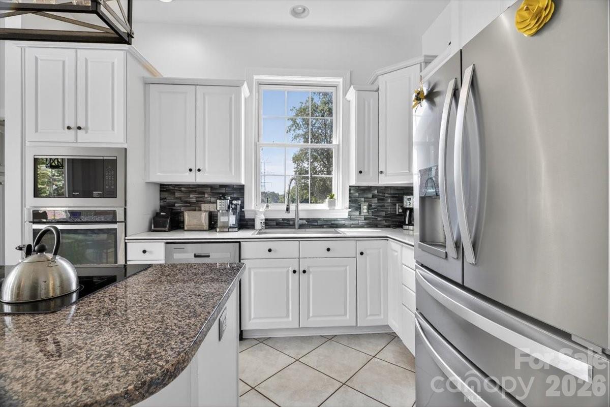 498 Johnson Dairy Road Mooresville, NC 28115 - Photo 11 of 43 a kitchen with stainless steel appliances granite countertop a refrigerator sink and stove