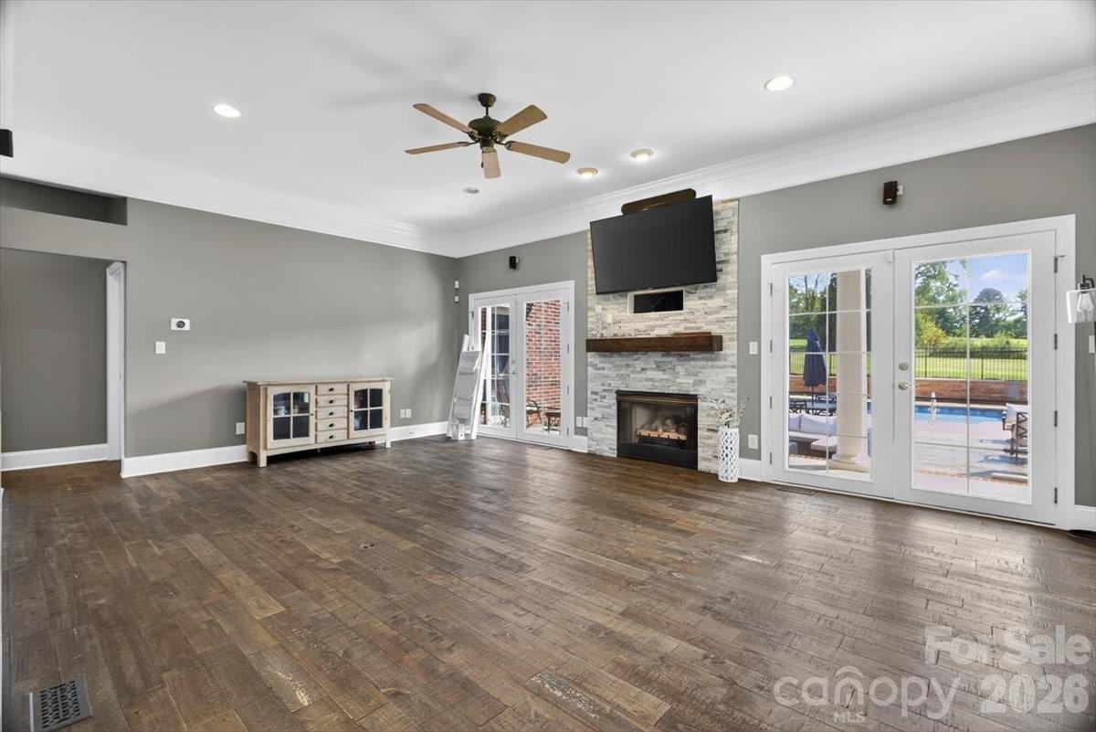 498 Johnson Dairy Road Mooresville, NC 28115 - Photo 17 of 43 a view of a livingroom with fireplace wooden floor and windows