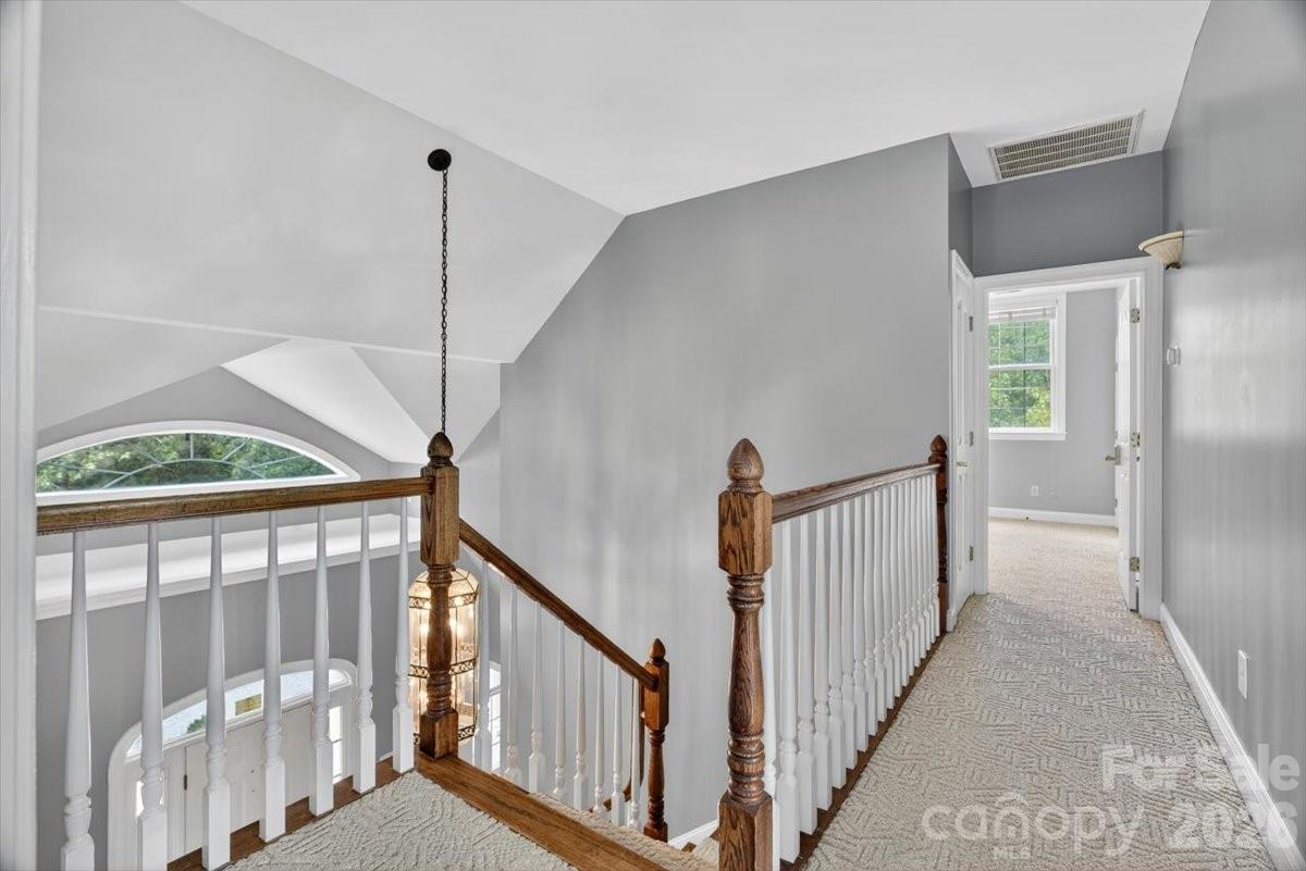 498 Johnson Dairy Road Mooresville, NC 28115 - Photo 27 of 43 a view of a hallway with wooden floor and stairs