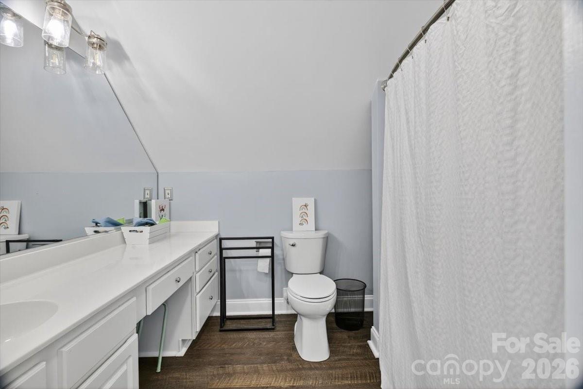 498 Johnson Dairy Road Mooresville, NC 28115 - Photo 29 of 43 a bathroom with a sink a toilet and shower curtain