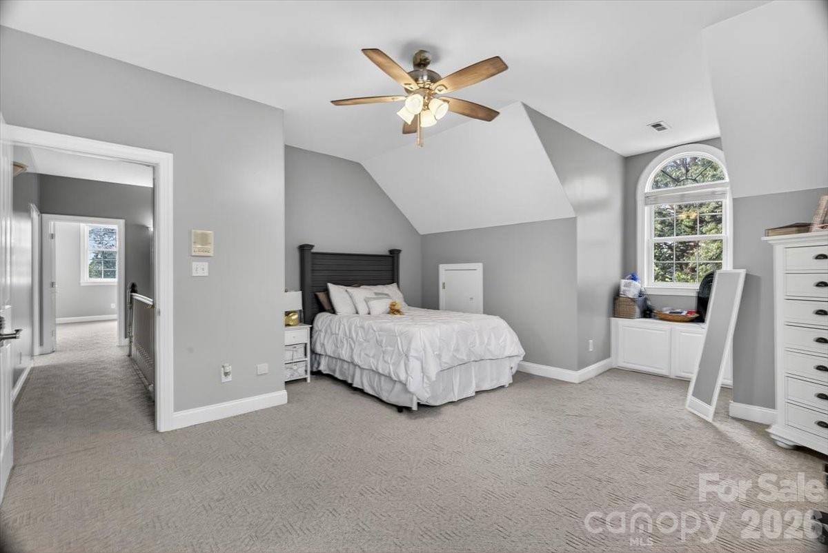 498 Johnson Dairy Road Mooresville, NC 28115 - Photo 31 of 43 a bedroom with a large bed and a ceiling fan