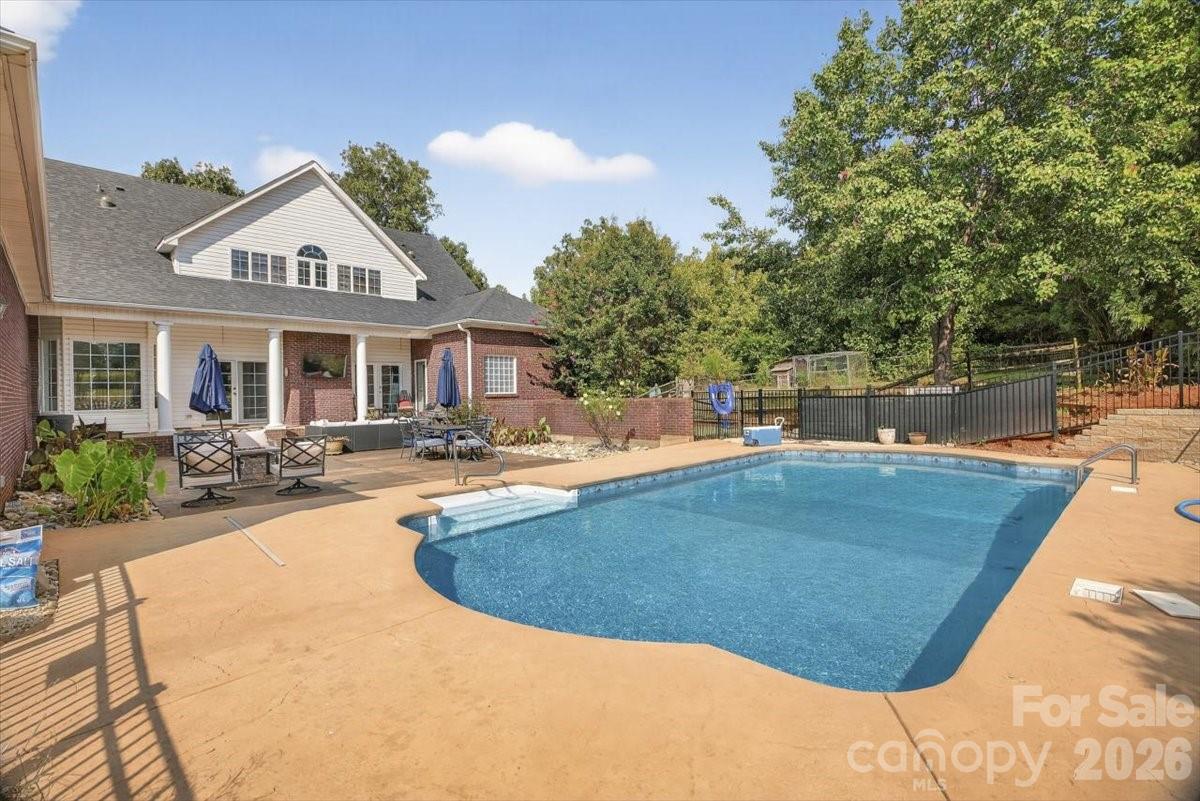 498 Johnson Dairy Road Mooresville, NC 28115 - Photo 36 of 43 a view of a house with swimming pool and a yard