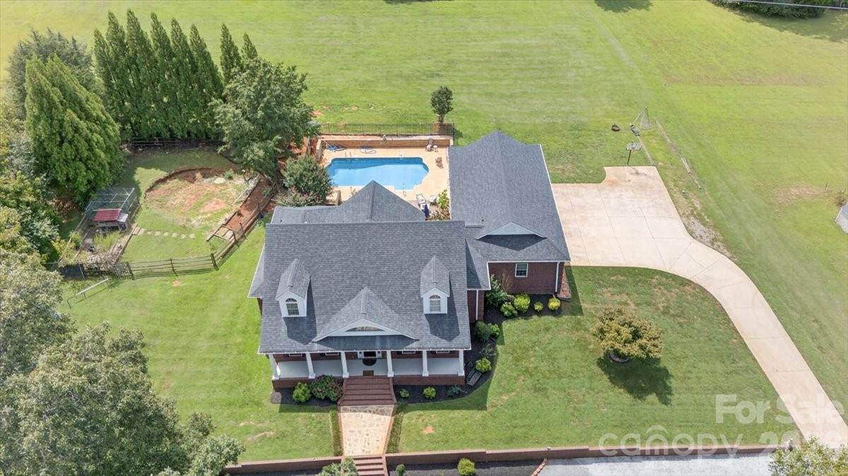 498 Johnson Dairy Road Mooresville, NC 28115 - Photo 40 of 43 an aerial view of a house with swimming pool and large trees