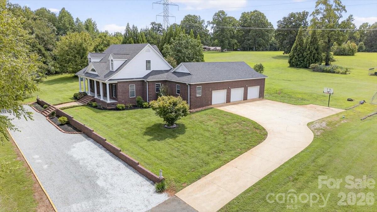 498 Johnson Dairy Road Mooresville, NC 28115 - Photo 41 of 43 a view of a house with a big yard potted plants and large tree