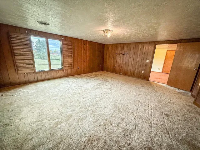 an empty room with windows and bathroom