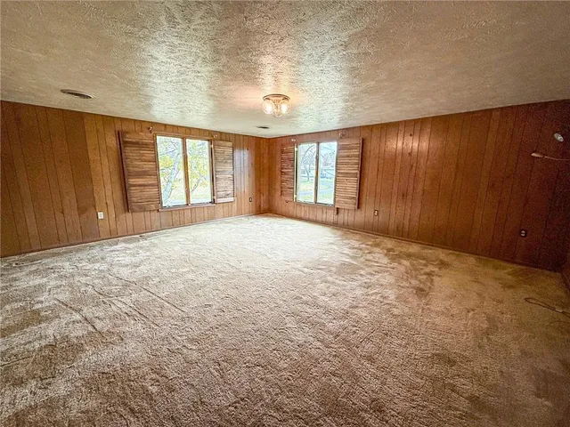a large bedroom with a large bed and wooden floor