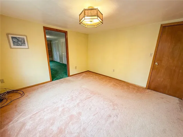 a view of an empty room with a fireplace