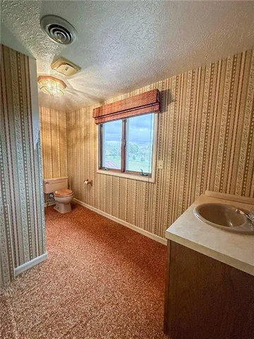 a view of an empty room with window and stairs